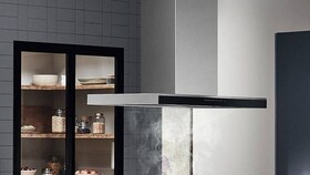 An Island and ceiling hood in a kitchen.