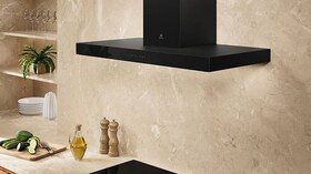 Wall-mounted cooker hoods in a kitchen.