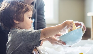 child helping with the dishes
