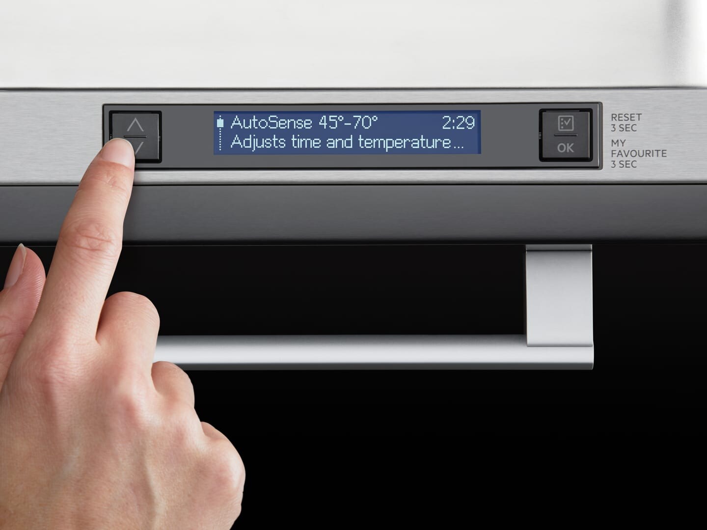 woman choosing programme on dishwasher
