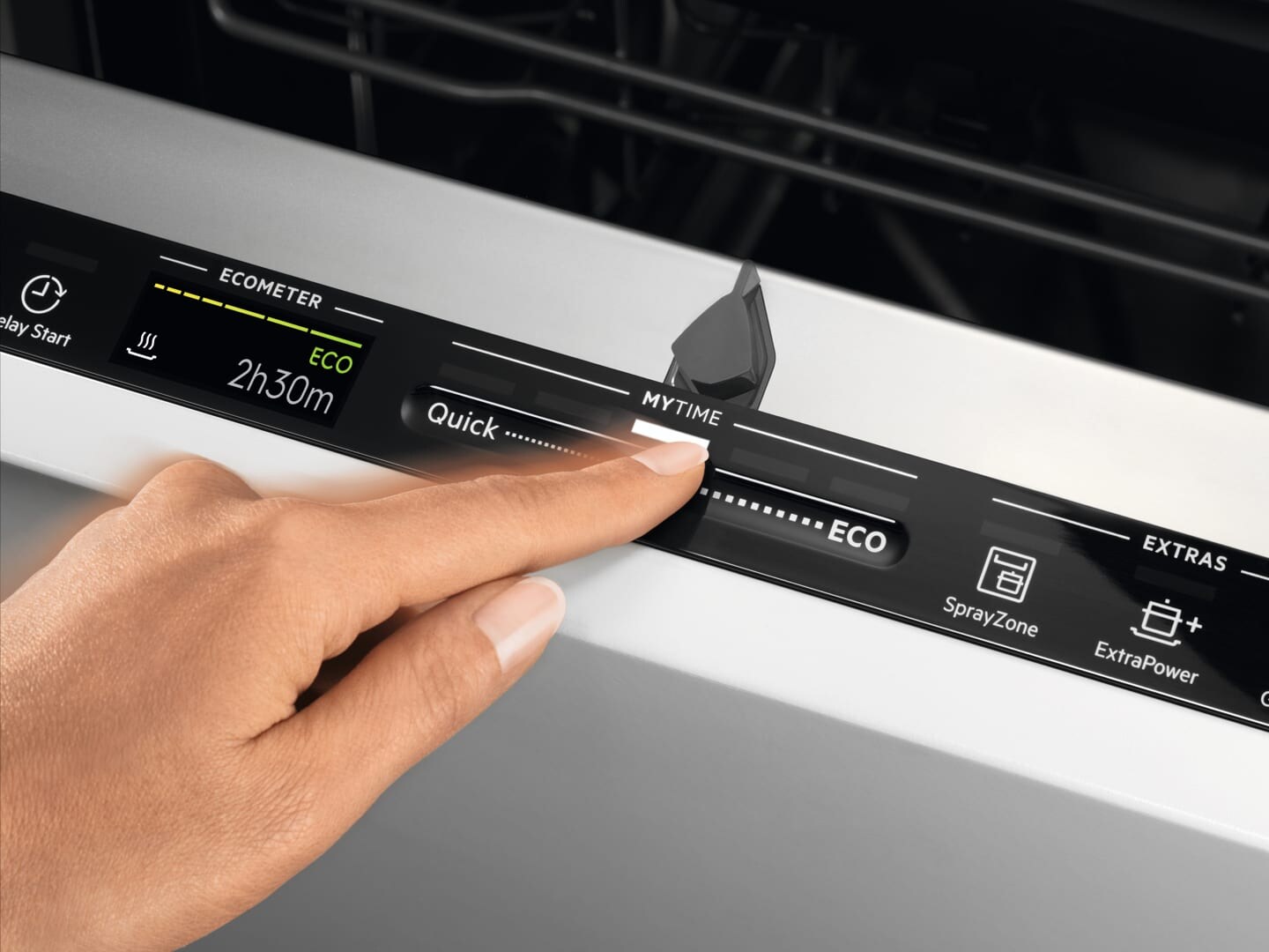 woman choosing program on dishwasher