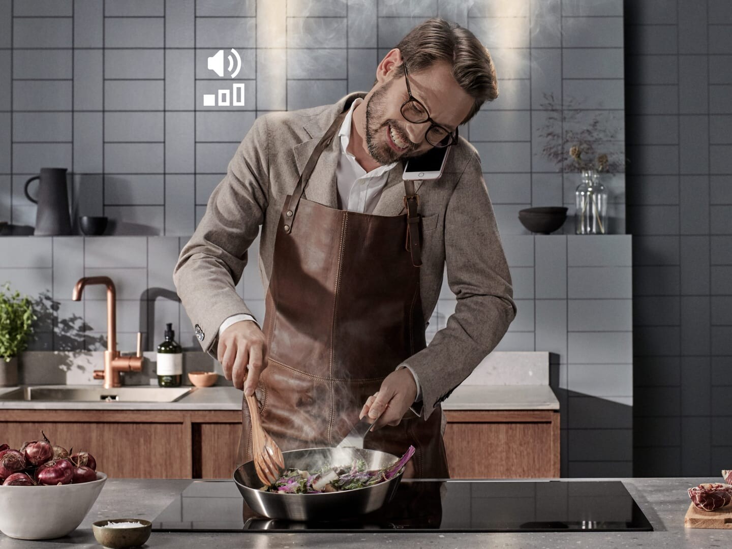 man cooking food and talking on the phone