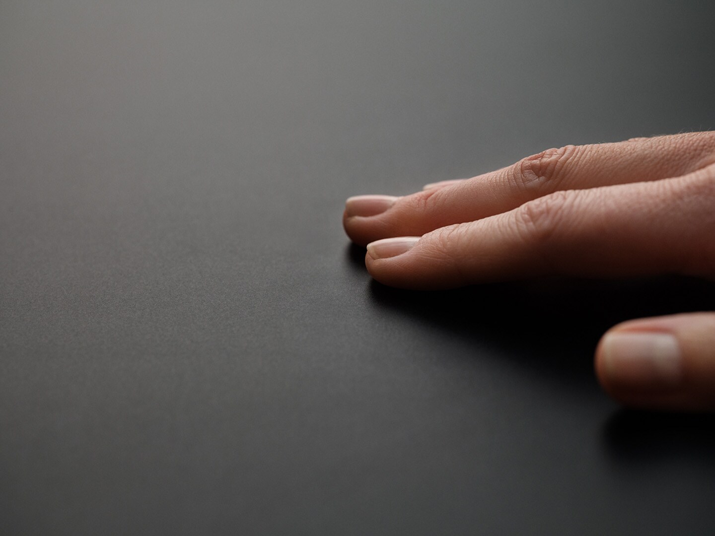 A hand is touching an induction hob