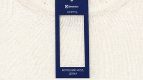 Белый шерстяной джемпер с ярлыком хорошего ухода Electrolux